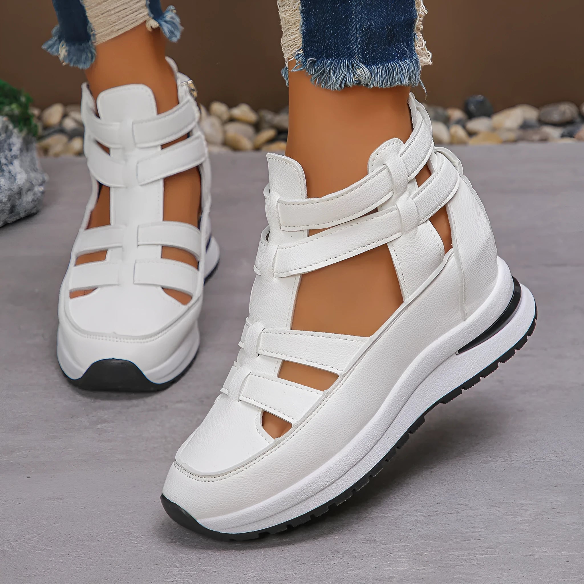 Black women's platform sandals with close toe, hollow-out sides, and a Velcro strap.