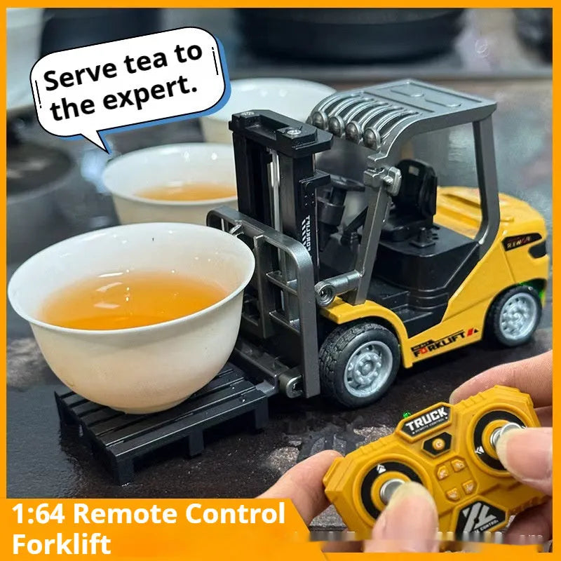 Remote control miniature alloy forklift on desk with remote control unit