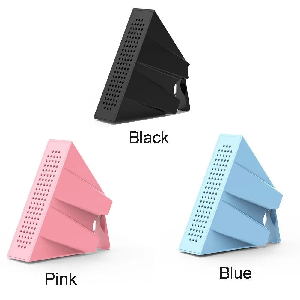 Pink iPhone speaker amplifier holder on a desk next to a mobile phone.