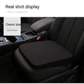 Black car heightening seat cushion with thick foam construction measuring 42x39x6cm