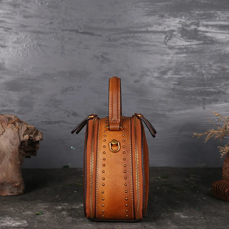 Vintage leather handbag showing internal organisation pockets including mobile phone compartment and ID bag