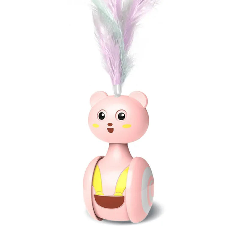Pink and blue cat tumbler toys with feather lures and rolling balls on a wooden floor.