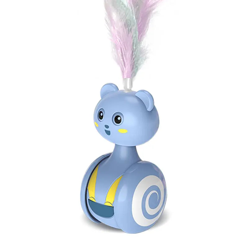 Pink and blue cat tumbler toys with feather lures and rolling balls on a wooden floor.