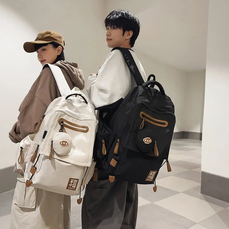 Street style large capacity nylon backpack for middle school students in solid colour with curved shoulder straps.