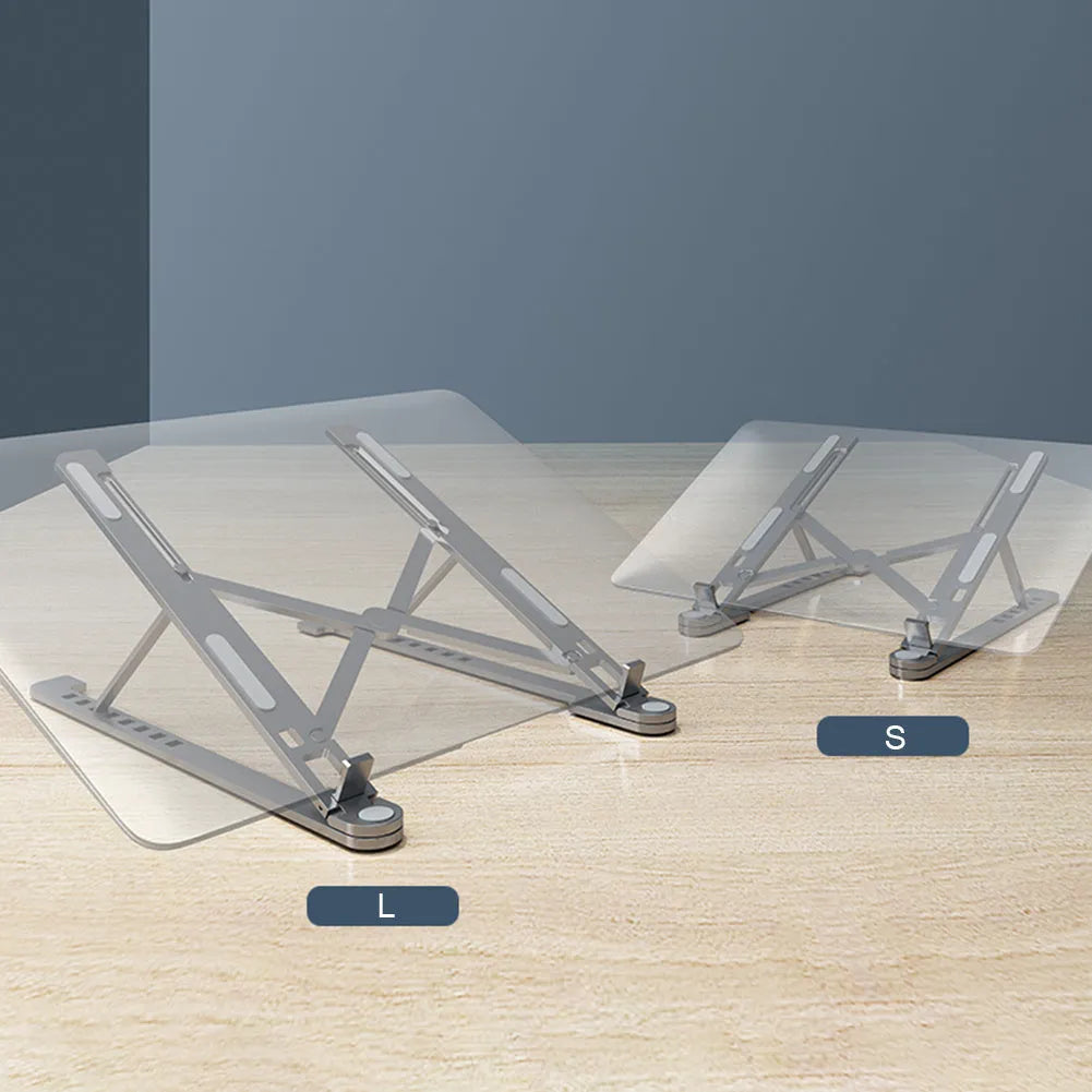 A folded deep grey aluminium laptop stand next to an open silver laptop on a desk.