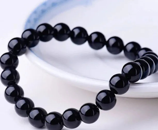 Geometric black agate bracelet with 8mm beads on elastic cord for women.
