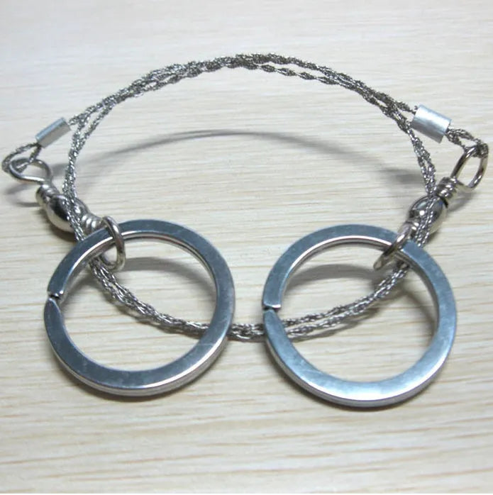 Survival wire saw with stainless steel blade and thumb rings for outdoor cutting tasks