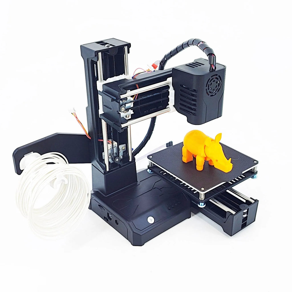 Black and blue K9 Mini desktop 3D printer on a table next to a small printed model.