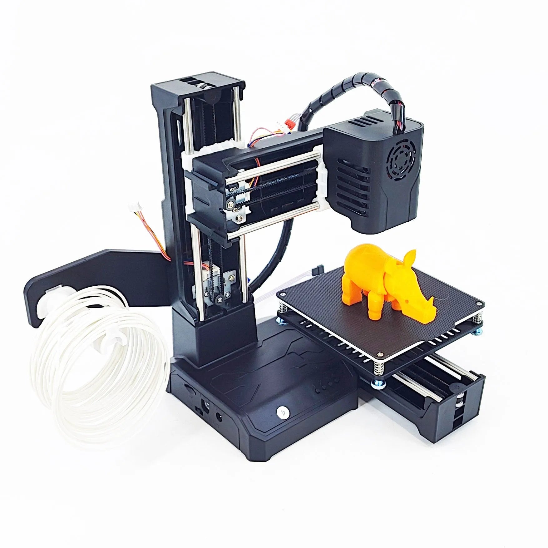 Black and blue K9 Mini desktop 3D printer on a table next to a small printed model.