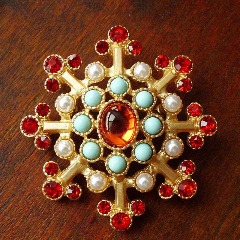 A selection of eight different zinc alloy retro baroque brooches in a diamond shape on a fabric background.