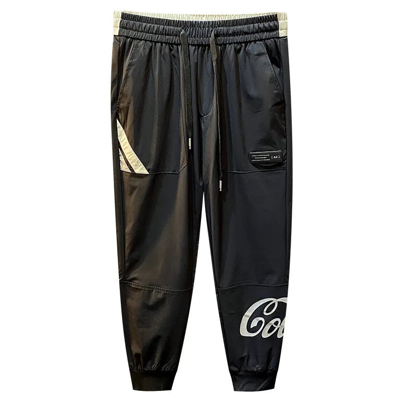 Men's black ice silk cropped ankle banded trousers on hanger showing thin fabric and banded ankle detail