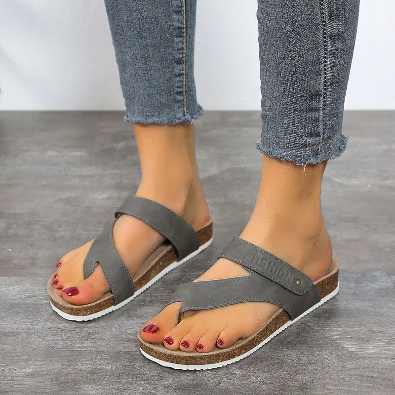 A pair of solid-colour flip-flops with a flat toe ring and thick foam sole.