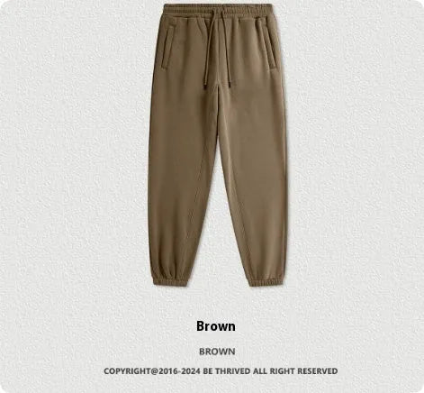 Men's solid colour velvet sweatpants with elasticated ankle banding in dark brown