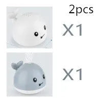 White and blue whale bath toy spraying water with LED lights illuminated