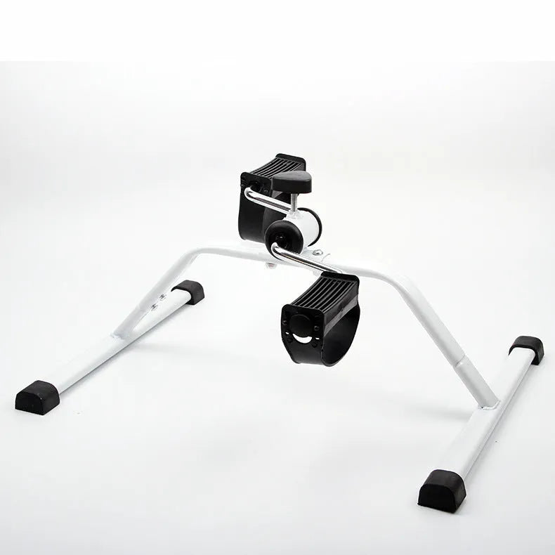 White mini exercise bike with non-slip pedals and monitor on rubber feet