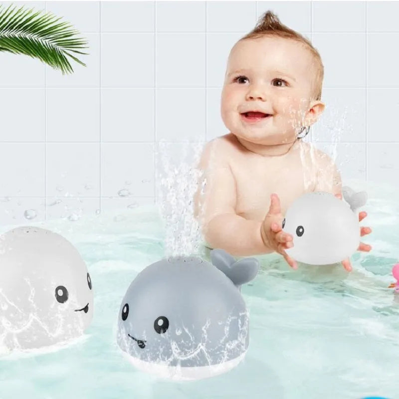 White and blue whale bath toy spraying water with LED lights illuminated