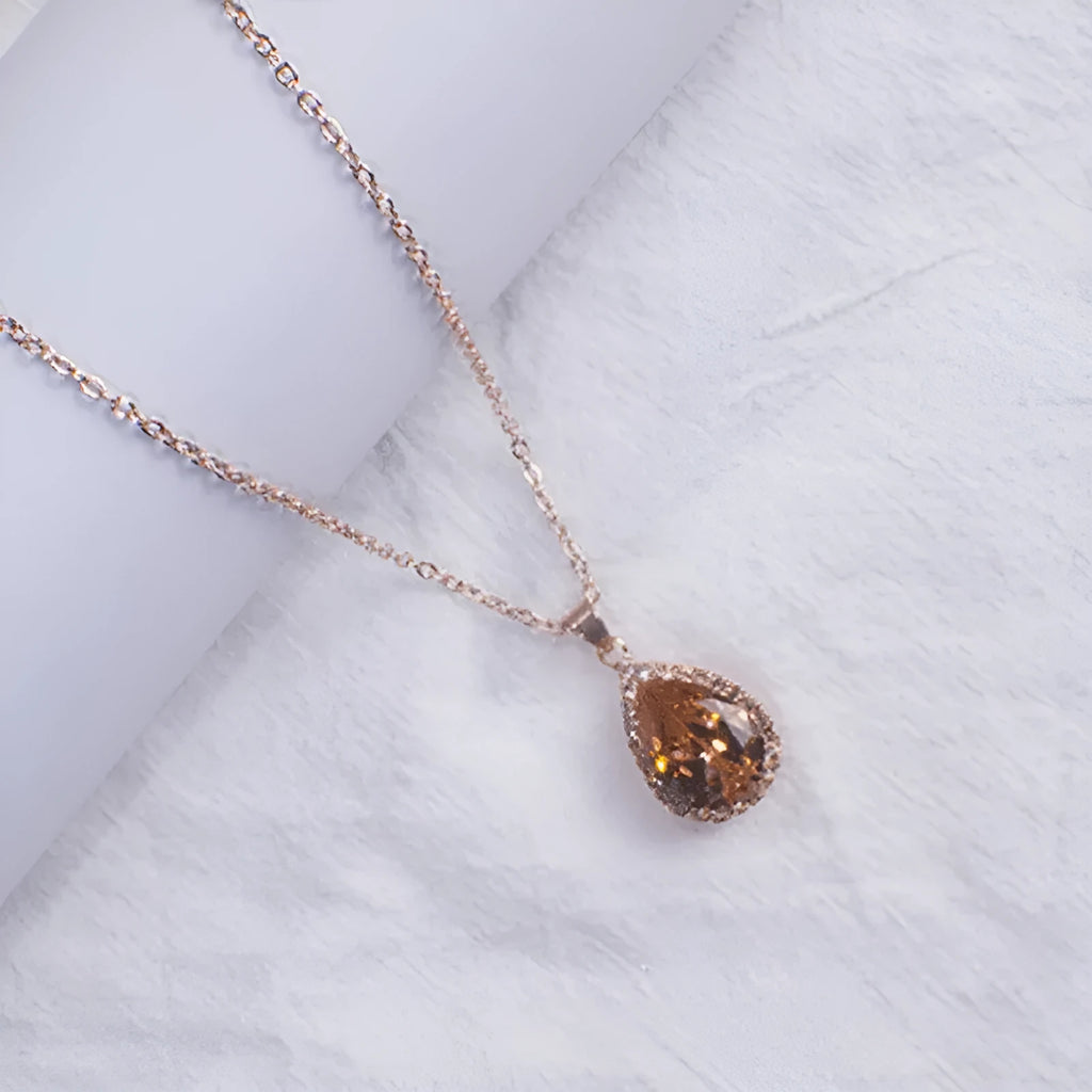 Women's geometric drop shape alloy necklace with rhinestone accents in rose gold pink colour