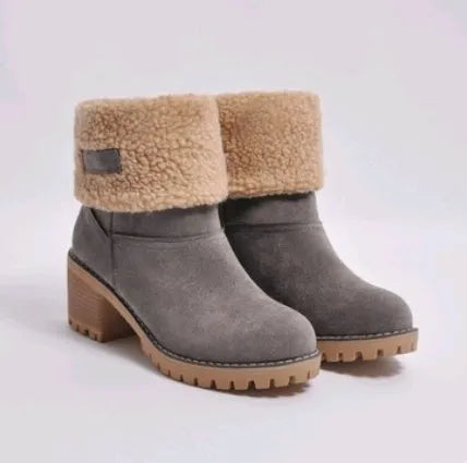 Women's black suede mid-tube snow boots with a thick heel and round toe on a waterproof platform sole.