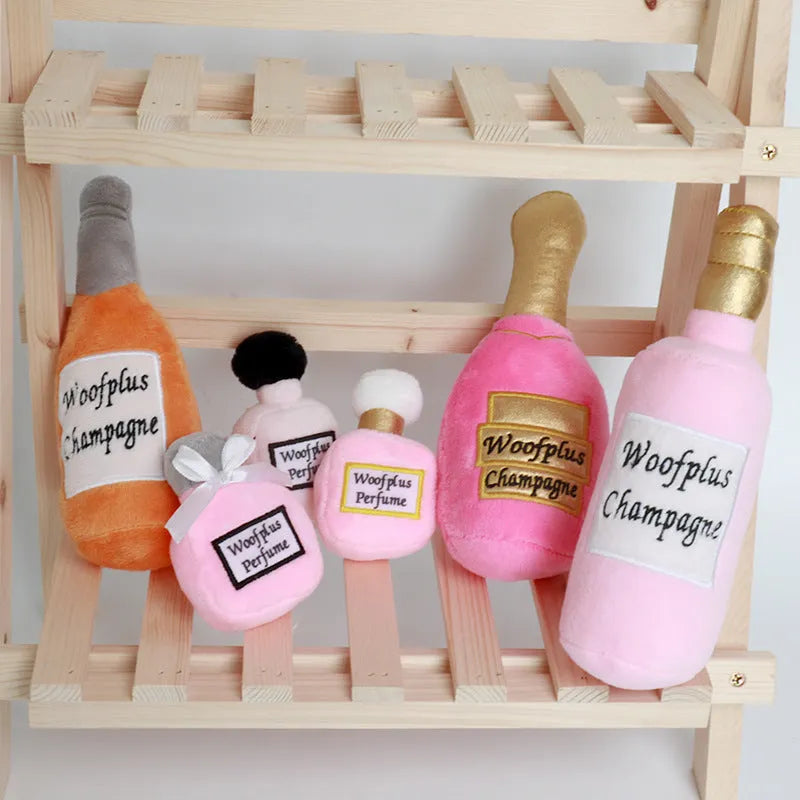 Soft green plush wine bottle pet toy for dogs and cats on a white background.