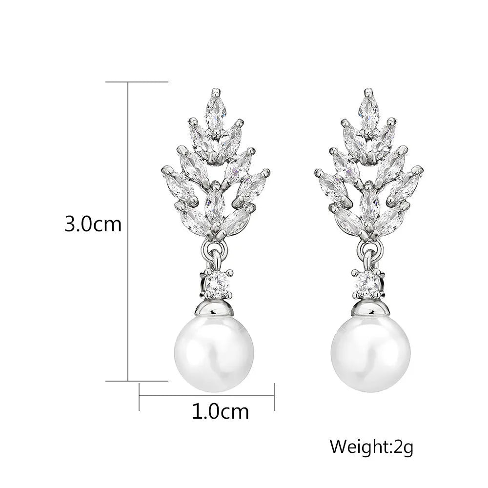 Geometric floral earrings with micro inlaid zircon and pearl details on copper with gold plating