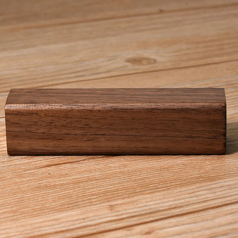 Solid walnut wood portable power bank with 2000mAh battery showing dimensions of 100mm x 25mm x 25mm