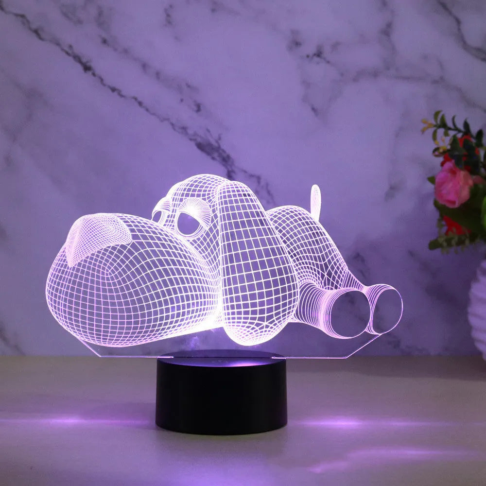 Doggo desktop lamp with 3D illusion design glowing in multiple colours on a desk.