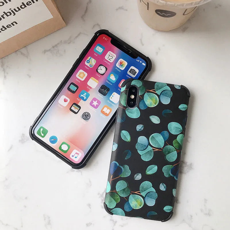 Black silicone iPhone case featuring a detailed leaf print design on the back.