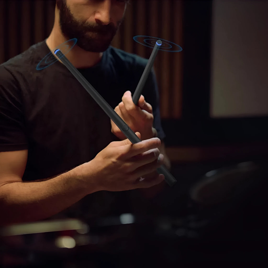 Black somatosensory air drum kit with wireless drumsticks and LED lighting on a dark surface