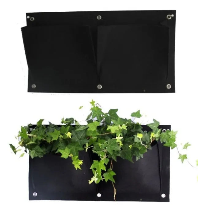 Green felt vertical wall planter with multiple planting pockets hanging on an outdoor wall