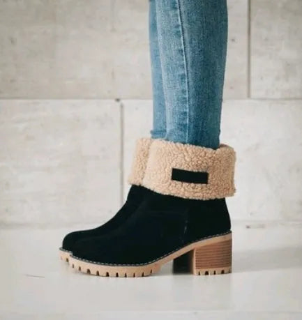 Women's black suede mid-tube snow boots with a thick heel and round toe on a waterproof platform sole.