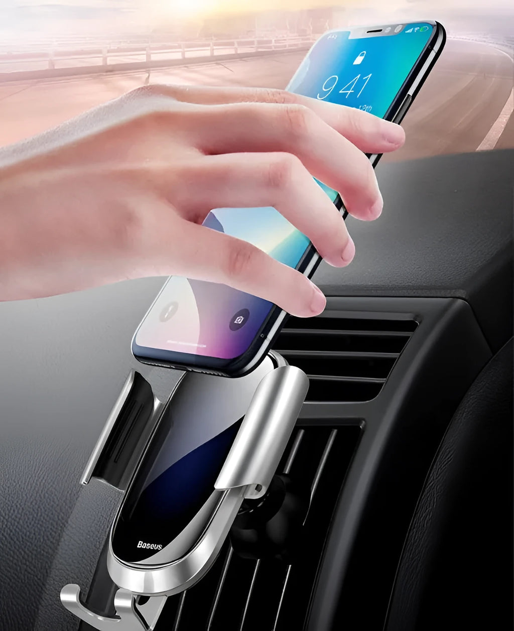 Universal smart car bracket holding smartphone, showing adjustable gripping arms in silvery metallic finish