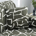 Stretchable geometric print sofa slipcover covering a three-seater sofa with matching pillow