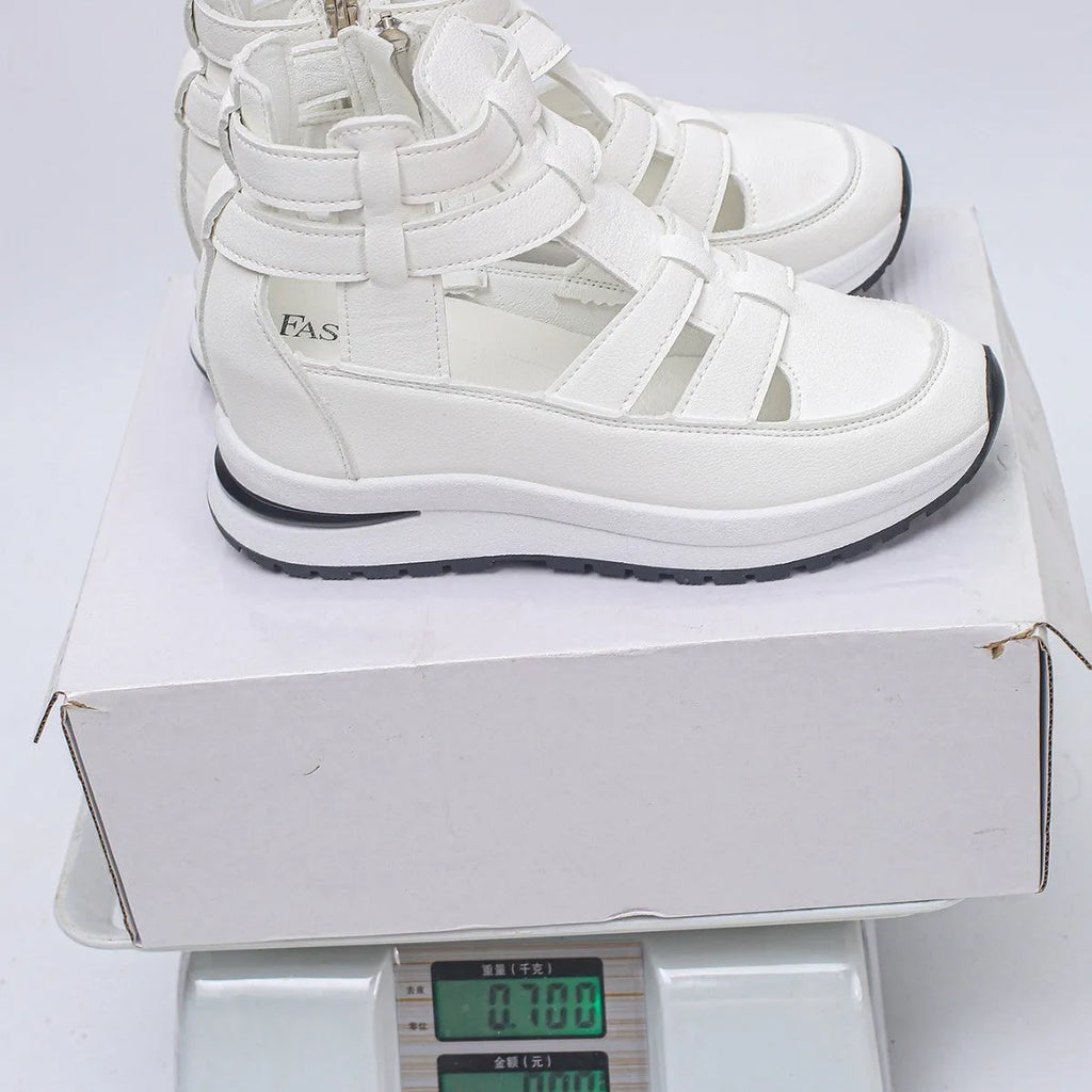 Black women's platform sandals with close toe, hollow-out sides, and a Velcro strap.