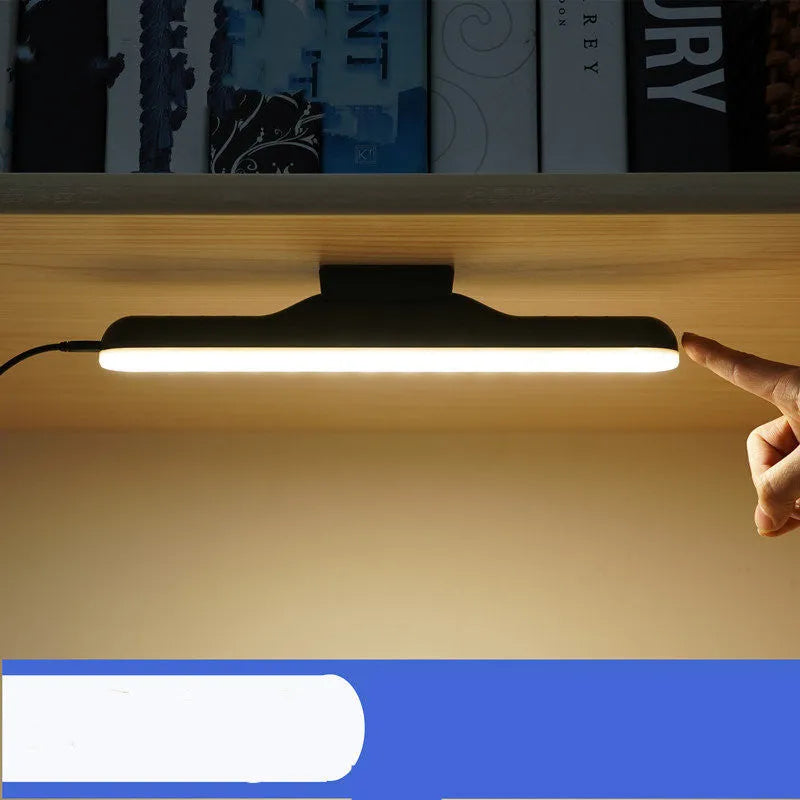 Modern simple white plastic LED desk lamp with touch switch and in-line power cord on a wooden desk.