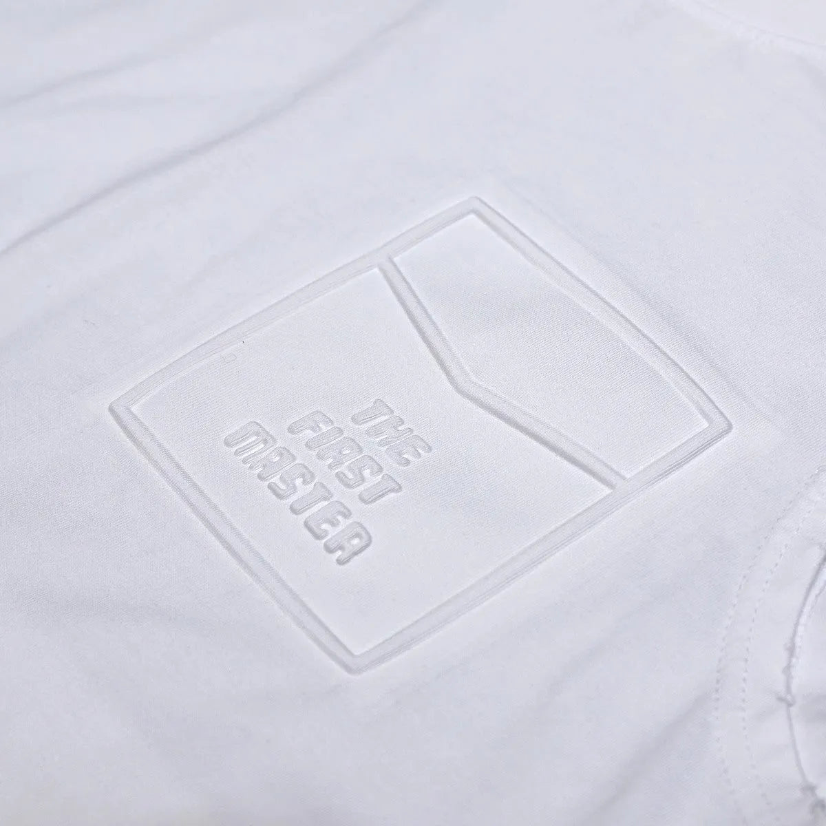 A solid colour loose cotton sleeveless t-shirt on a hanger, shown in white and black.