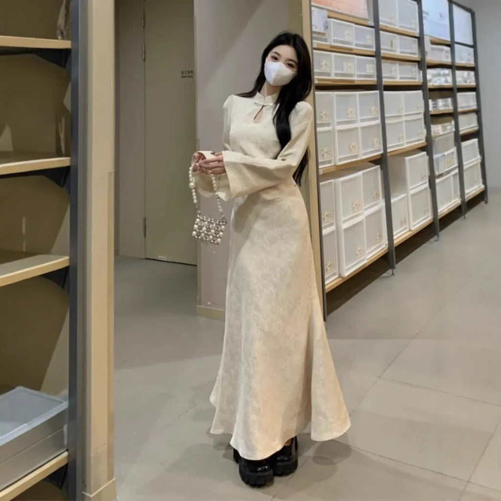 Plus size cheongsam dress in black with waist-tight draping effect and long sleeves