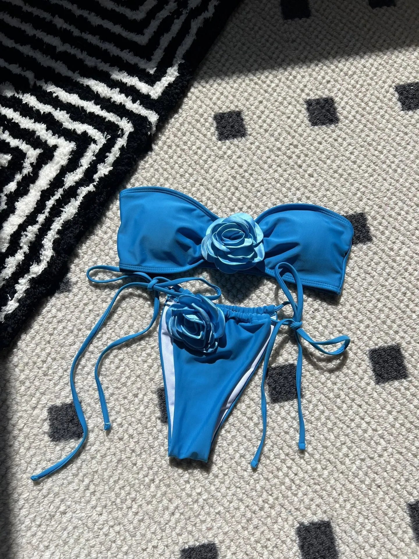Solid colour women's tube top swimsuit with drawstring straps on a mannequin.