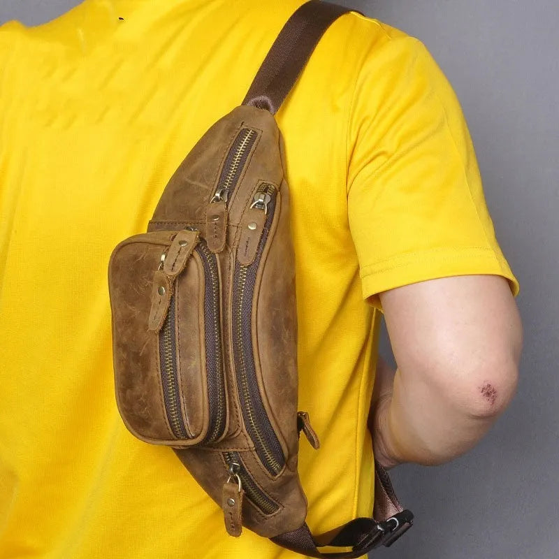 Brown leather retro messenger bag with a single shoulder strap shown open