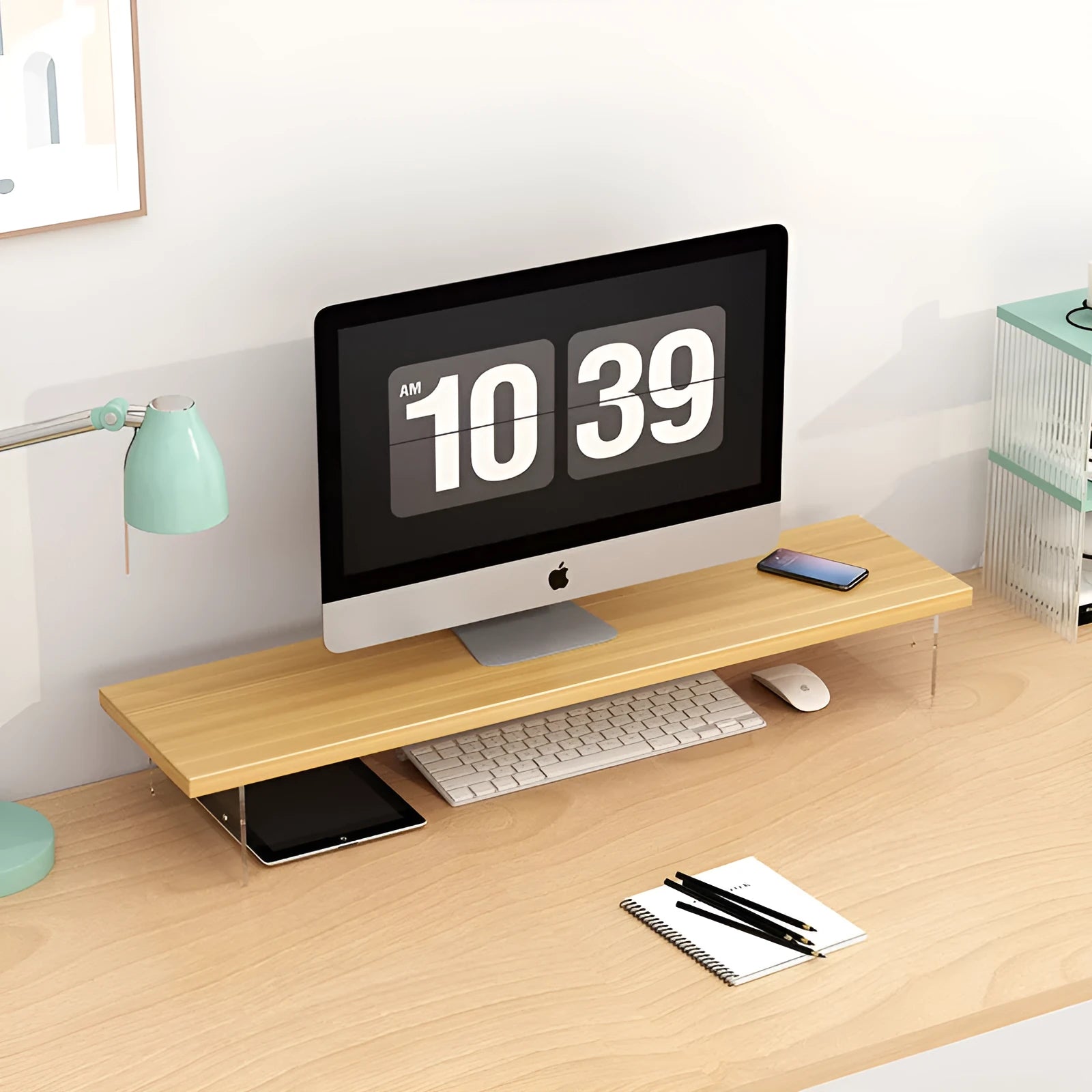 Black computer riser with acrylic legs on desk under monitor