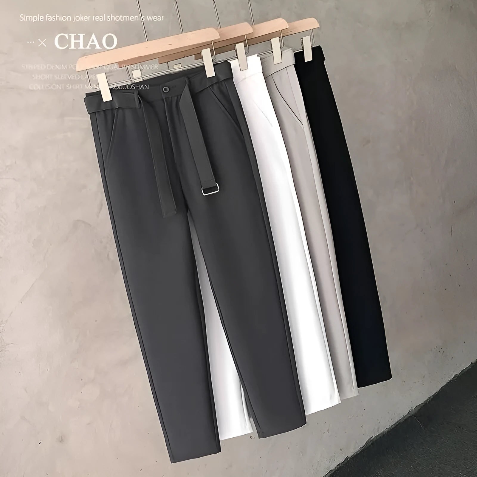 Boy wearing slim straight wool trousers in a neutral colour, showing tapered leg and straight hem.