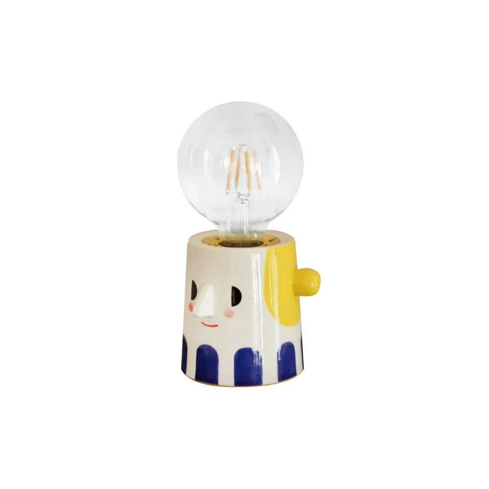 Handmade ceramic bedside lamp with ball headlight design on wooden nightstand