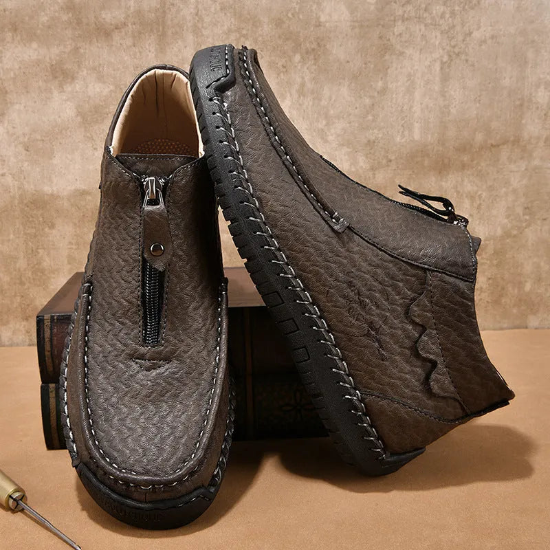 Men's black slip-on loafers with round toe and flat rubber sole on a white background.