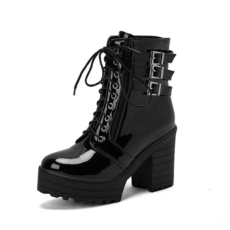 Women's black ankle boot with a thick rubber heel, round toe, and front lace-up closure on a waterproof platform.