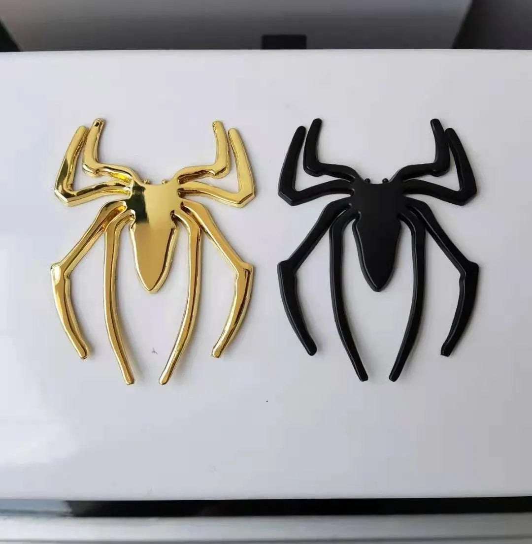 Three-dimensional metal spider bumper sticker in zinc alloy, showing gold colour option.