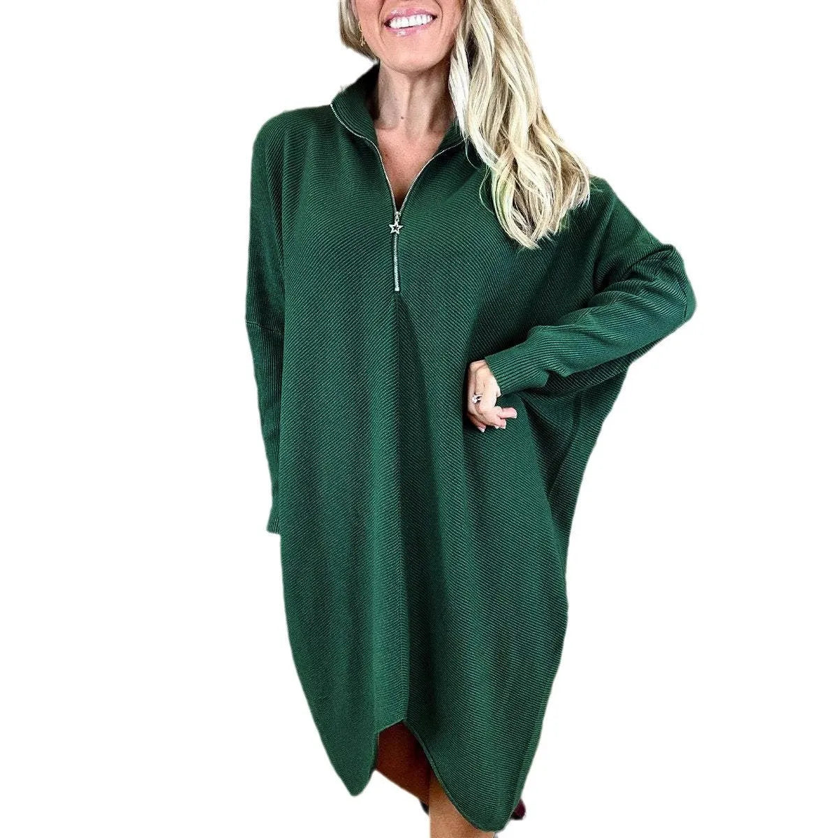 A woman wearing a loose-fitting solid colour knitted dress with raglan sleeves and a front zipper.