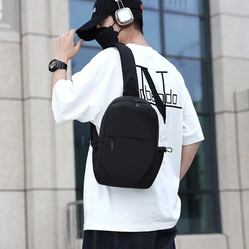Mens grey waterproof chest bag showing front compartment and shoulder strap