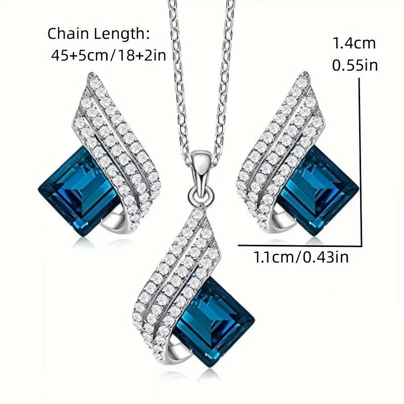 Women's jewellery set showing necklace with cross chain and matching earrings with glass elements