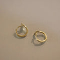 S925 sterling silver fishtail drop earrings in gold colour, showing smooth design and size.