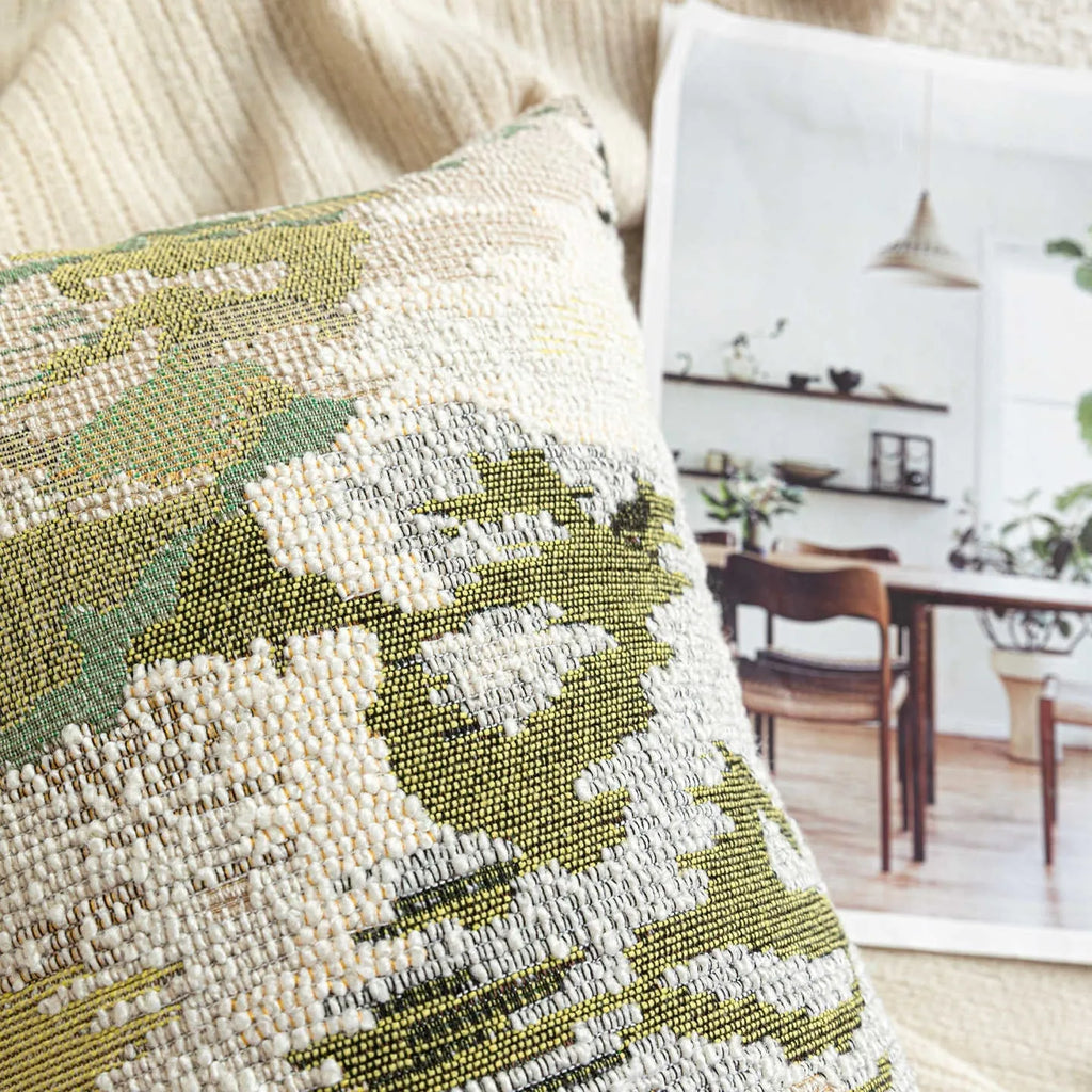 Antique green wool blend cushion cover with abstract spring flowers pattern, shown in square and lumbar sizes.