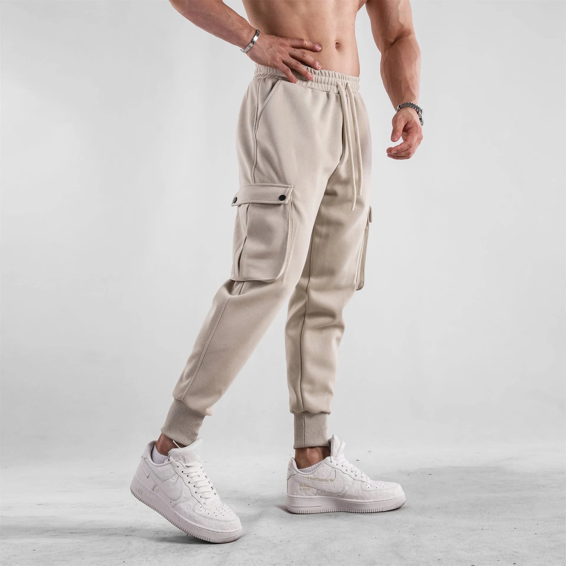 Men's loose-fit ankle-tied cotton sports trousers in solid colour with multi-pocket design